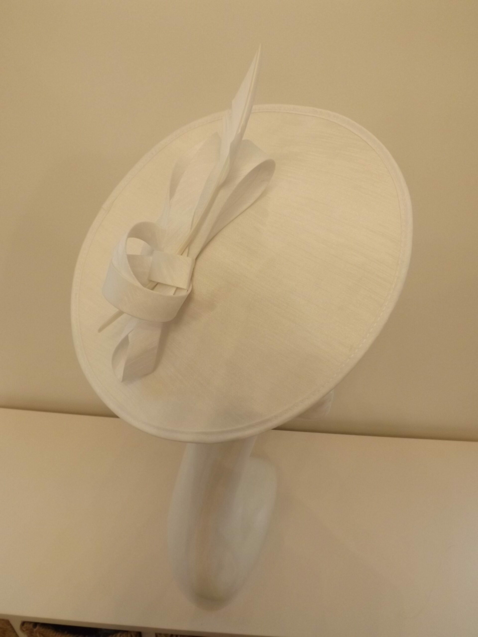Winter white silk disc fascinator on a headband Hat Hire