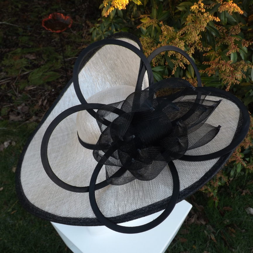 Large cream shimmer hatinator with black embellishment Hat Hire